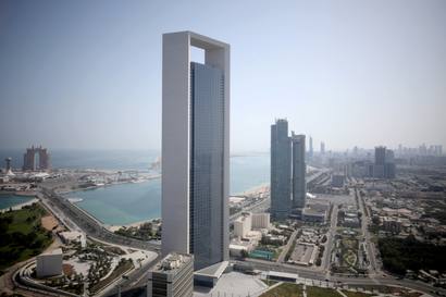 A grey skyscraper overlooks the Persian Gulf in the United Arab Emirates..