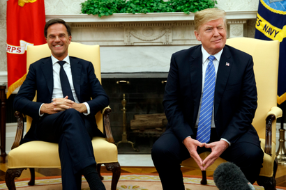 President Donald Trump winks at reporters during a meeting with Dutch Prime Minister Mark Rutte in the Oval Office of the White House, Monday, July 2, 2018, in Washington.