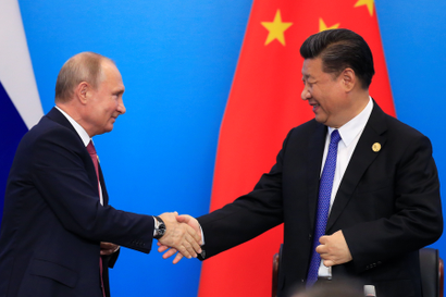 China's President Xi Jinping and Russia's President Vladimir Putin shake hands during Shanghai Cooperation Organization (SCO) summit in Qingdao, Shandong Province, China June 10, 2018.
