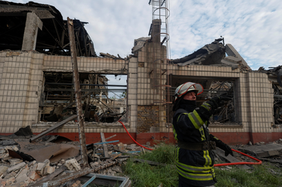 A rescuer works at a site of a facility of the Darnytsia Car Repair Plant damaged by missile strikes, as Russia's attacks Ukraine in continues, in Kyiv.