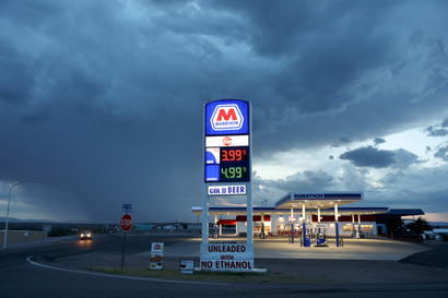 Gas prices are displayed at a gas station near the drought-stricken Elephant Butte Reservoir, as monsoon rain falls in the distance, on August 16, 2022 near Truth or Consequences, New Mexico. 