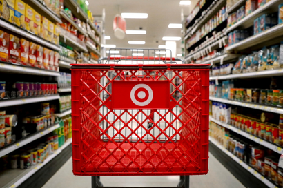 A view of a red Target shopping cart in the center of a grocery isle.