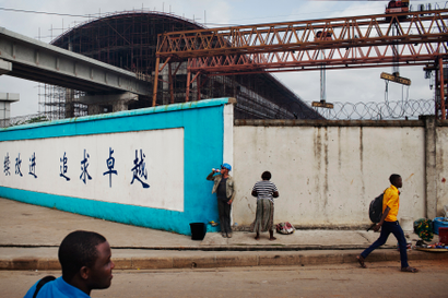 Pedestrians pass by a construction site of Lagos Rail Mass Transit system in Lagos in 2013.