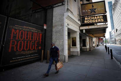 A man walks by Broadway theaters closed due to Covid-19