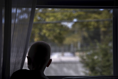 5-year-old Baraka Cosmas Lusambo from Tanzania looks out the window in the Staten Island borough of New York, September 21, 2015. Albino body parts are highly valued in witchcraft and can fetch a high price. Superstition leads many to believe albino children are ghosts who bring bad luck. Some believe the limbs are more potent if the victims scream during amputation, according to a 2013 United Nations report. Albinism is a congenital disorder affecting about one in 20,000 people worldwide who lack pigment in their skin, hair and eyes. It is more common in sub-Saharan Africa and affects about one Tanzanian in 1,400. United Nations officials estimate about 75 albinos have been killed in the east African nation since 2000 and have voiced fears of rising attacks ahead of this year's election, as politicians seek good luck charms from witch doctors. Picture taken September 21, 2015. REUTERS/Carlo Allegri - RTS2I7H