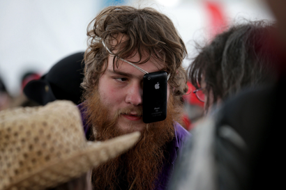 A man uses a iPhone as a eye patch