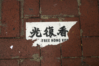 A Hong Kong protest sticker is seen on the sidewalk in Hong Kong