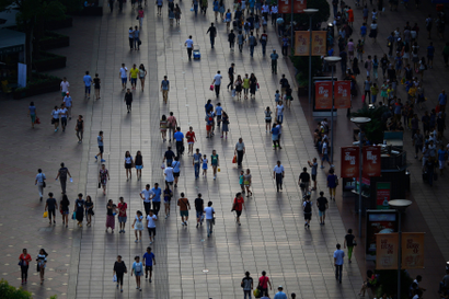 People walks along a pedestrian section of Nanjing road in downtown Shanghai