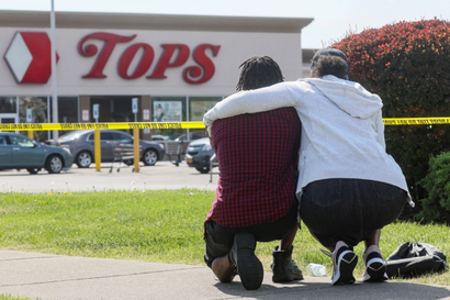 Mourners attend a vigil for victims of a racist shooting at a Buffalo supermarket.