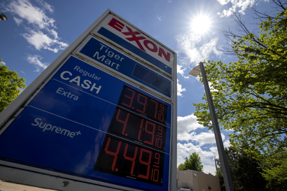 Gas prices are seen on a billboard are at an Exxon gas station. The sign reads $3.97 a barrel.
