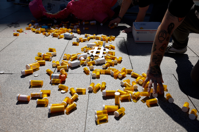 WASHINGTON, DC - OCTOBER 06: Empty pill bottles from a piñata are scattered on the sidewalk during a protest against the price of prescription drug costs in front of the U.S. Department of Health and Human Services (HHS) building on October 06, 2022 in Washington, DC. The demonstration was sponsored by the Make Meds Affordable campaign, which is a campaign to call on Health and Human Services Secretary Xavier Becerra to take executive action to lower drug prices. 