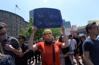 A woman holds up a sign during a demonstration by Wayfair employees protesting the company's sales of beds and furniture to U.S. border detention facilities, on Copley Plaza in Boston, Massachusetts, U.S., June 26, 2019.