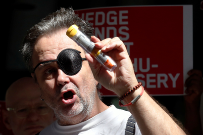 A man holds up an EpiPen during a protest against high prices for the drug injector.