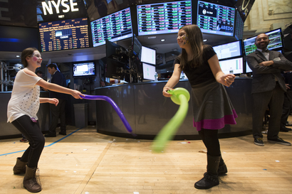 Children play during the trading day on the floor of the New York Stock Exchange.