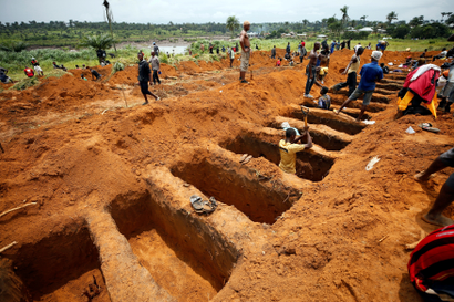 Workers are digging graves at the Paloko cemetery in Waterloo, Sierra Leone August 17, 2017.