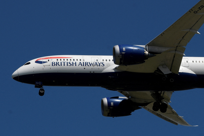 A British Airways plane flies in the air.