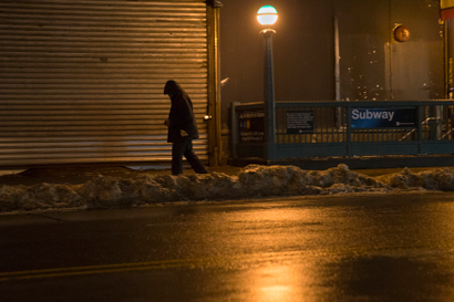 A man walks along the street in the Brooklyn borough of New York