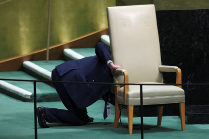 A worker prepares to remove a chair reserved for heads of state from the stage during the 73rd session of the United Nations General Assembly in New York, U.S., September 27, 2018. REUTERS/Carlo Allegri - RC1E36432030