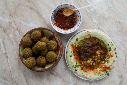 Chickpea-based hummus and falafel on table.
