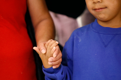 Darwin Micheal Mejia, right, holds hands with his mother, Beata Mariana de Jesus Mejia-Mejia, during a news conference following their reunion at Baltimore-Washington International Thurgood Marshall Airport, Friday, June 22, 2018, in Linthicum, Md. The Justice Department agreed to release Mejia-Mejia's son after she sued the U.S. government in order to be reunited following their separation at the U.S. border. She has filed for political asylum in the U.S. following a trek from Guatemala. (AP Photo/Patrick Semansky)