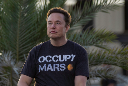Elon Musk wearing an Occupy Mars shirt
