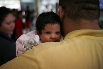 An undocumented immigrant father with his infant daughter