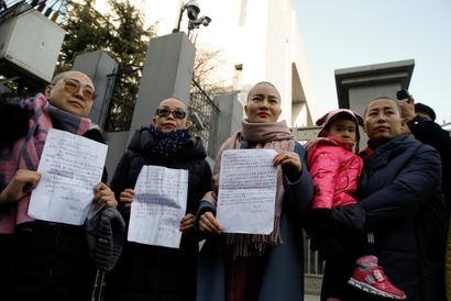 The wives of prominent Chinese rights lawyers Wang Qiaoling, Liu Ermin, Li Wenzu and Yuan Shanshan pose with petition letters they unsuccessfully tried to lodge at China's Supreme People's Court to protest their husband's treatment by the government in Beijing, China, December 17, 2018.