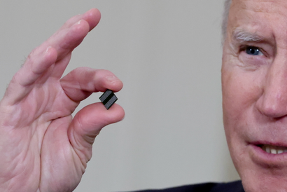 U.S. President Joe Biden holds a semiconductor chip.