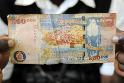 A man displays a 50,000 Kwacha note in Lusaka