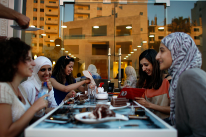 Palestinian women sit together at a newly opened upscale Italian cafe in the West Bank city of Ramallah