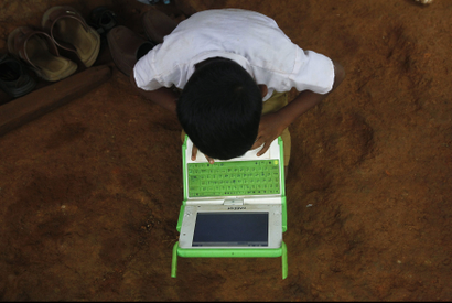 A school boy uses a laptop provided under the "One Laptop Per Child' project by a non-governmental organisation (NGO), in a state-run primary school in Khairat