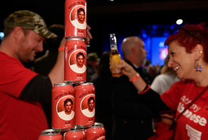 Supporters are seen with beer cans with the word Albo on it while they wait for Anthony Albanese, leader of Australia's Labor Party, to speak about the outcome of the country's general election.