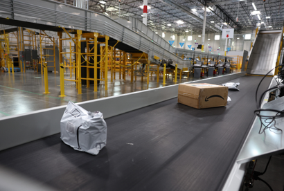 Packages move on a conveyor belt at a new Amazon same day shipping facility on November 23, 2022 in Richmond, California. Amazon opened a 200,000 square foot same day shipping facility that can deliver some packages within hours of the order being received. 