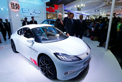 awan Goenka, president of Mahindra's automotive and farm equipment sectors, stands next to Mahindra's concept electric sports car 'Halo' after its unveiling during the Indian Auto Expo in Greater Noida,