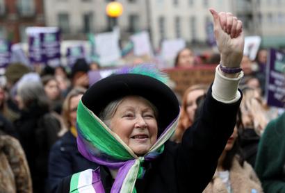 A woman dressed as suffragette.