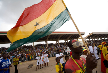 A man holds the Ghana flag