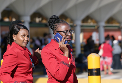 A Kenya Airways flight attendant uses her cell phone as they gather at the Jomo Kenyatta International Airport during a labour dispute that grounded flights near Nairobi, Kenya March 6, 2019.