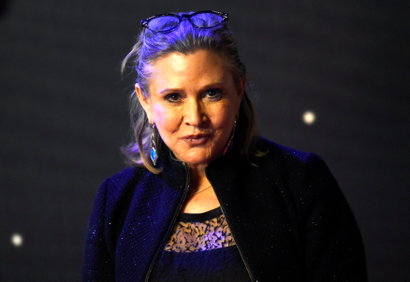 Carrie Fisher poses for cameras as she arrives at the European Premiere of "Star Wars, The Force Awakens"