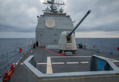A war ship is shown sailing in the ocean. 