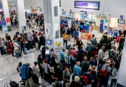 Tourists wait at a Thomas Cook company counter at Heraklion airport on the island of Crete on Sept. 23.