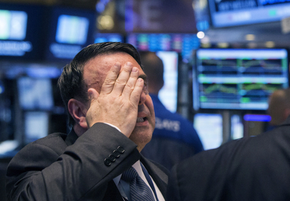 An NYSE official gestures in despair
