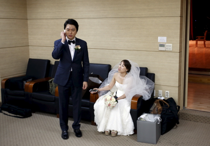 A bridal couple gets ready for their wedding ceremony at a budget wedding hall at the National Library of Korea in Seoul, South Korea.