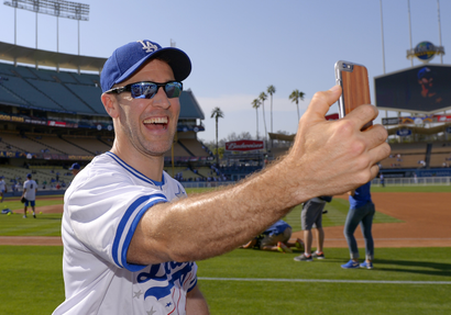 Actor James Van Der Beek broadcasts live via Periscope prior to a celebrity baseball game before a game between the Los Angeles Dodgers and the St. Louis Cardinals, Saturday, June 6, 2015, in Los Angeles. (AP Photo/Mark J. Terrill)