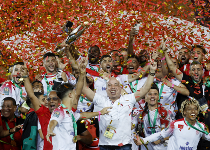Players and staff of Wydad AC lift the CAF Champions League trophy in a sea of confetti