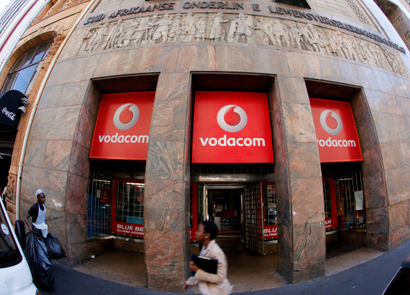 Someone walking past a branch of South African mobile communications provider Vodacom in Cape Town
