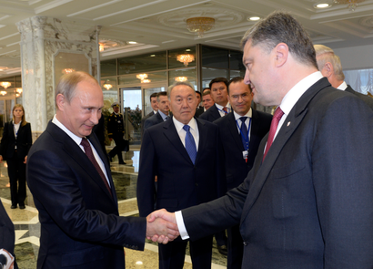 Russian President Vladimir Putin (L) shakes hands with his Ukrainian counterpart Petro Poroshenko, as Kazakh President Nursultan Nazarbayev (C) stands nearby, in Minsk August 26, 2014.