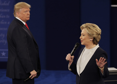 Republican presidential nominee Donald Trump listens to Democratic presidential nominee Hillary Clinton during the second presidential debate at Washington University in St. Louis, Sunday, Oct. 9, 2016.