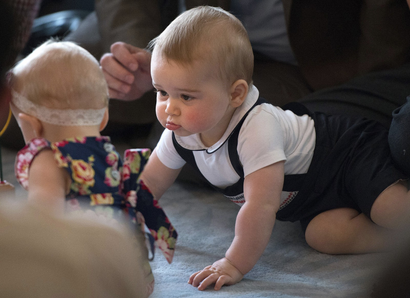 Prince George, son of Britain's Prince William and his wife Catherine, the Duchess of Cambridge, looks at other babies during a Plunket nurse and parents group event at the Government House in Wellington April 9, 2014. Royal New Zealand Plunket Society, or Plunket for short, is a national not-for-profit organisation that provides care for children and families in New Zealand. Britain's Prince William and his wife Kate are undertaking a 19-day official visit to New Zealand and Australia with their son George. REUTERS/Marty Melville/Pool (NEW ZEALAND - Tags: ROYALS ENTERTAINMENT TPX IMAGES OF THE DAY) - RTR3KJ7H