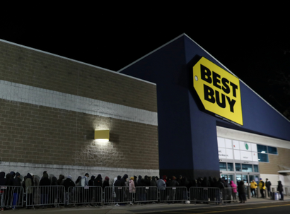 People wait in line to shop at Best Buy