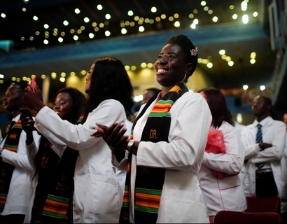 Students from Ghana take part in a graduation ceremony of the University of Medical Sciences of Havana in Havana, Cuba. The students are wearing white robes and a kente cloth sash.